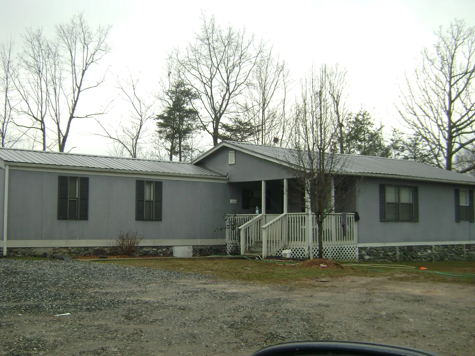 Metal roof over a manufactured home with a covered front porch in Ludlow